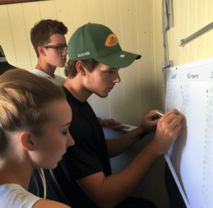Young volunteers signing up for shifts on a whiteboard